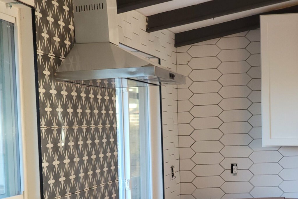 Denver kitchen updated with new white picket tile backsplash laid horizontally and a dark statement tile used over the oven/stovetop.