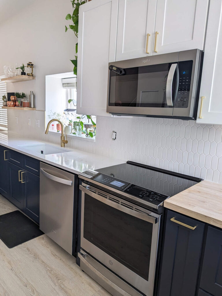 Remodeled kitchen in Denver, displaying new appliances including a stainless steel range, microwave, and dish washer.