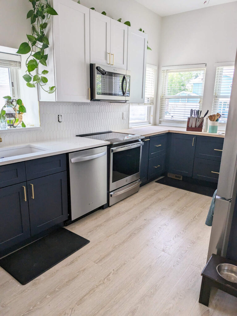 Denver kitchen remodeled with white upper cabinets and dark blue lower cabinets.