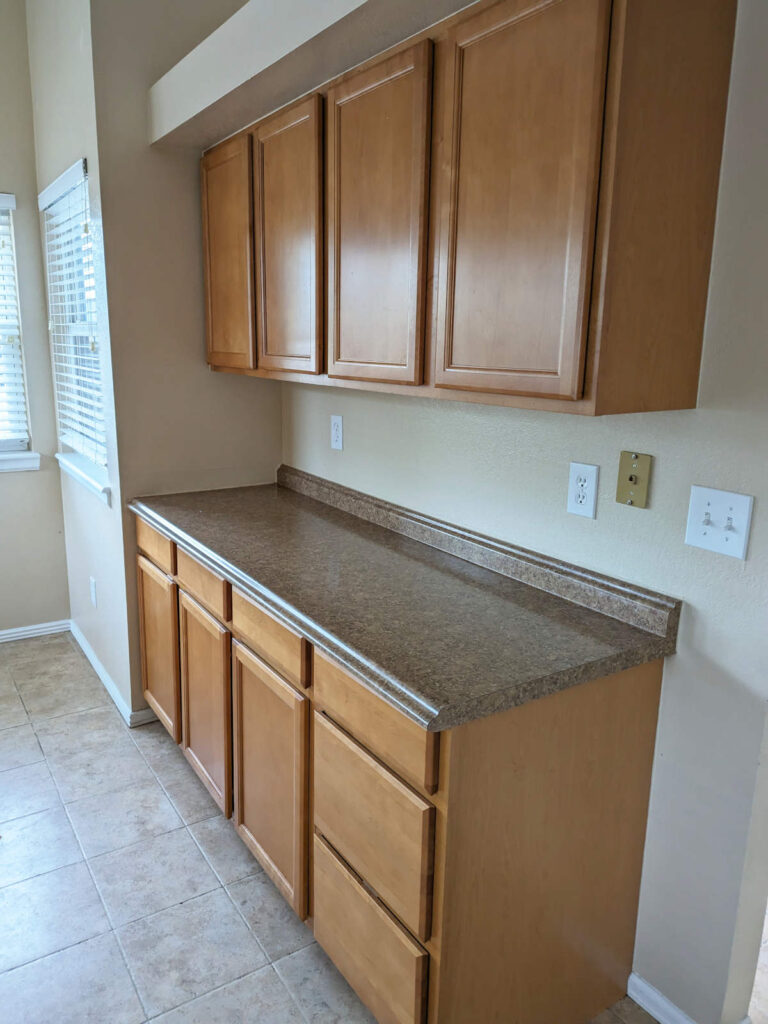 Denver kitchen before remodeling, with laminate countertops and wood cabinets.