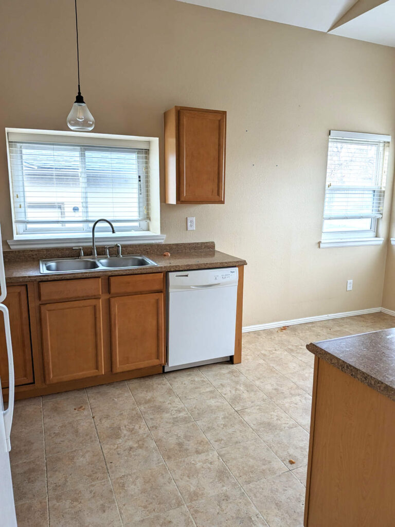 Denver kitchen before remodeling, with laminate countertops, wood cabinets, and white appliances.